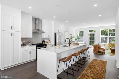 a kitchen with sink a stove and cabinets