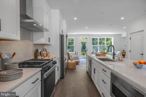 a kitchen with stainless steel appliances granite countertop a refrigerator and a stove