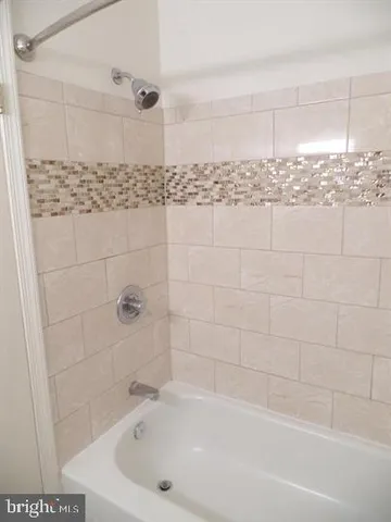 a bathroom with bathtub and shower