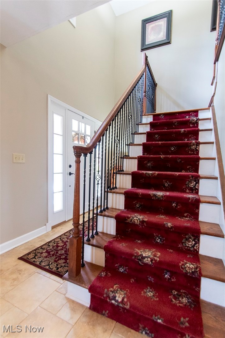 4041 Huffman Road Medina, OH 44256 - Photo 4 of 40 Stairs featuring tile patterned flooring and a towering ceiling