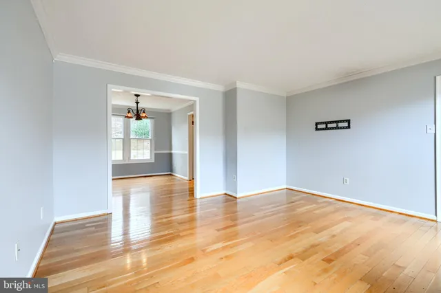 a view of a room with wooden floor and window