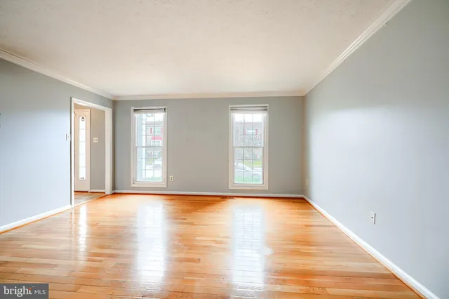 a view of a room with wooden floor and window