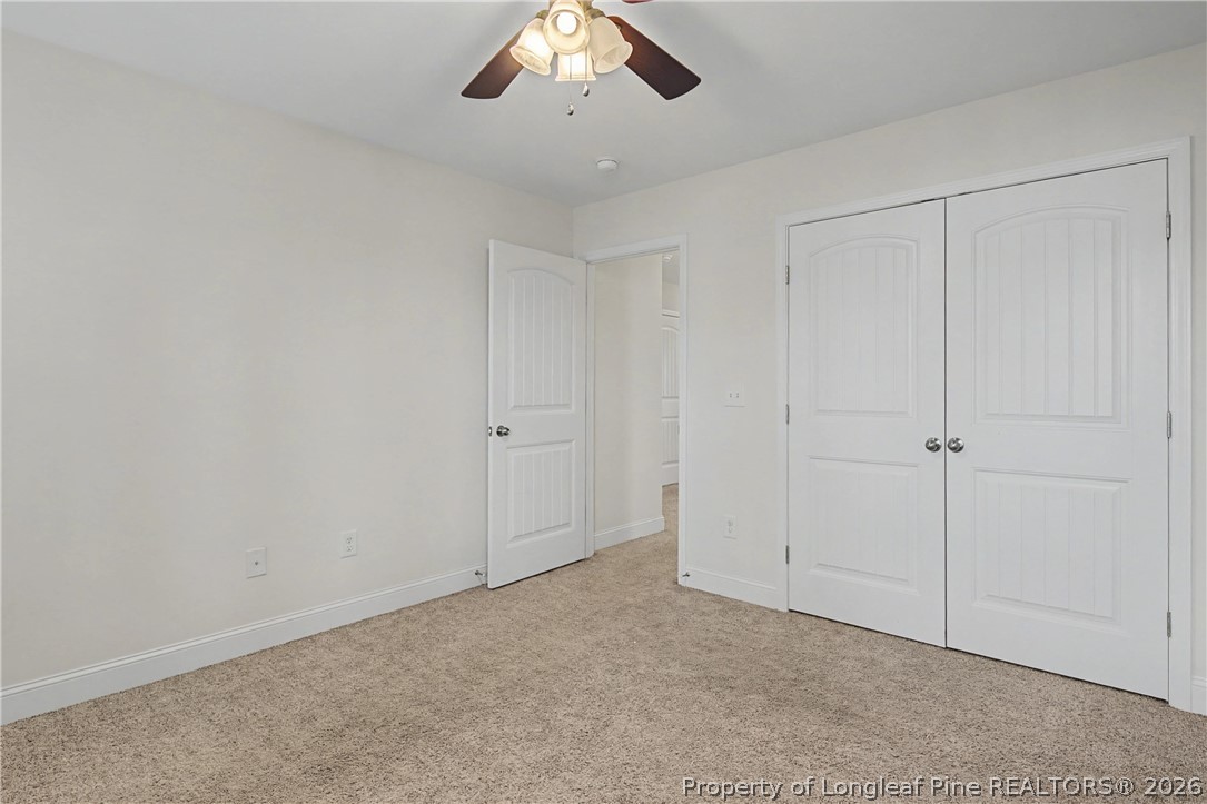 47 Pinnacle Drive Spring Lake, NC 28390 - Photo 28 of 50 an empty room with a chandelier fan