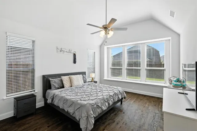 a bedroom with a large bed and a large window