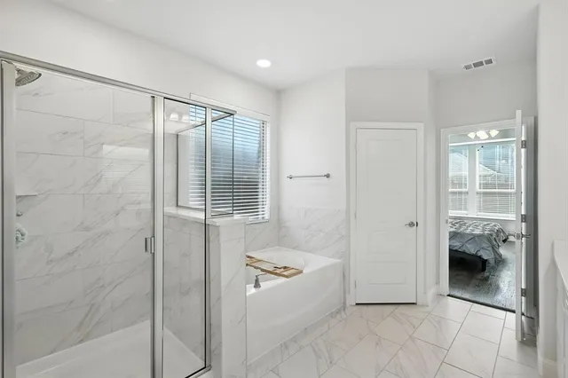 a bathroom with a tub and shower