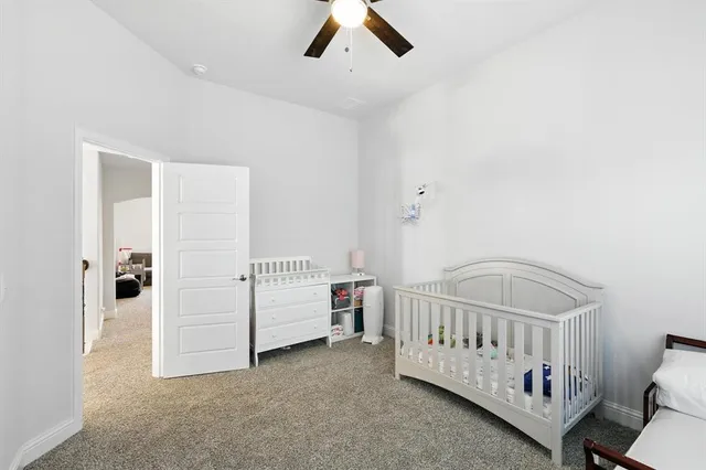a spacious bedroom with a bed and a flat screen tv