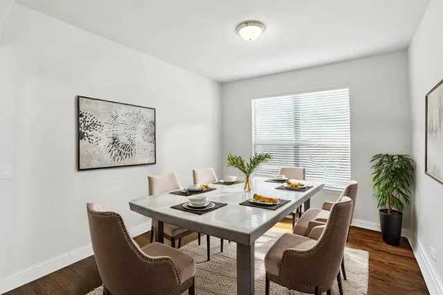 a view of a dining room with furniture window and wooden floor