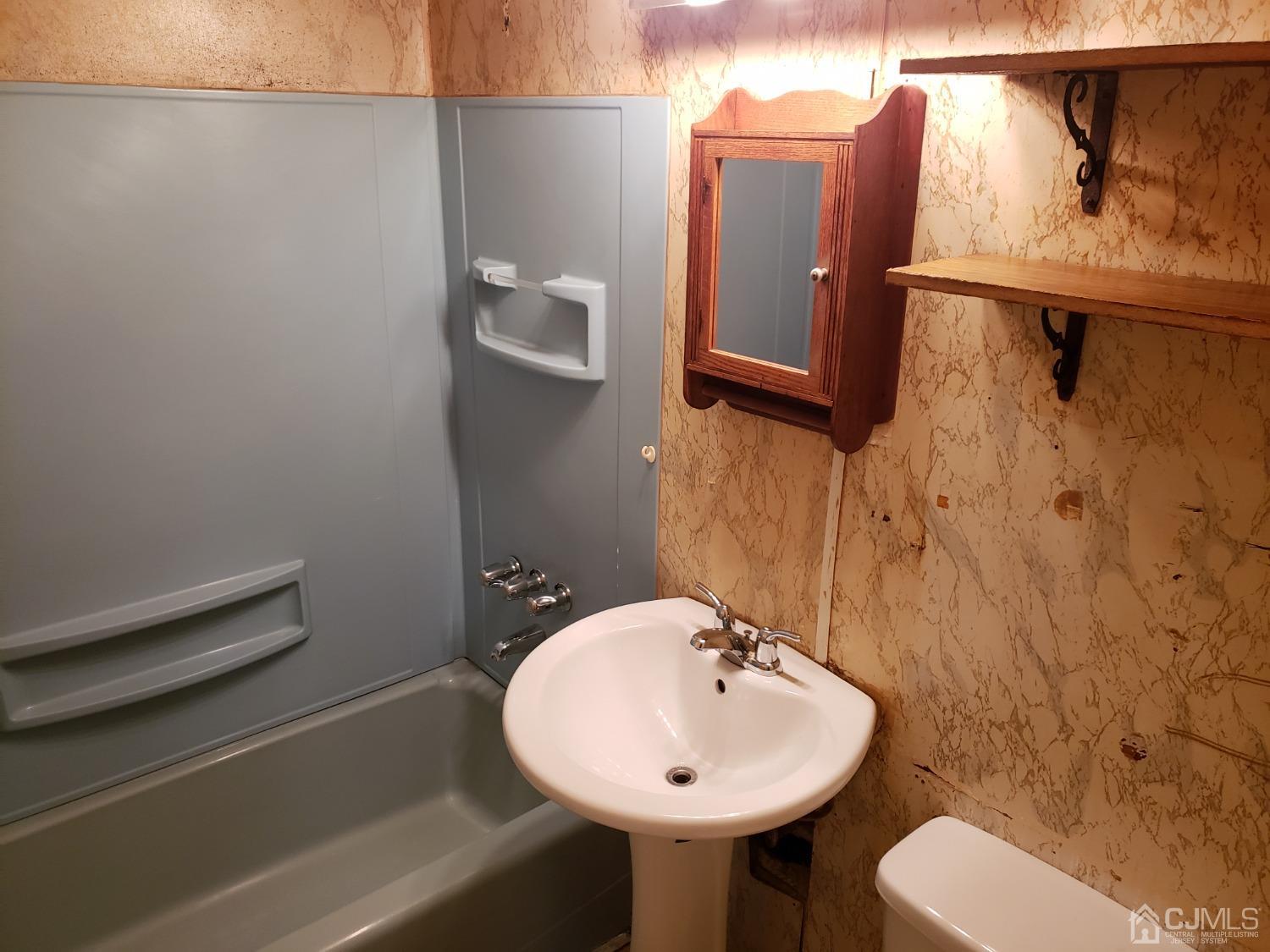 32 Crescent Road Edison, NJ 08817 - Photo 13 of 18 a bathroom with a sink toilet and mirror
