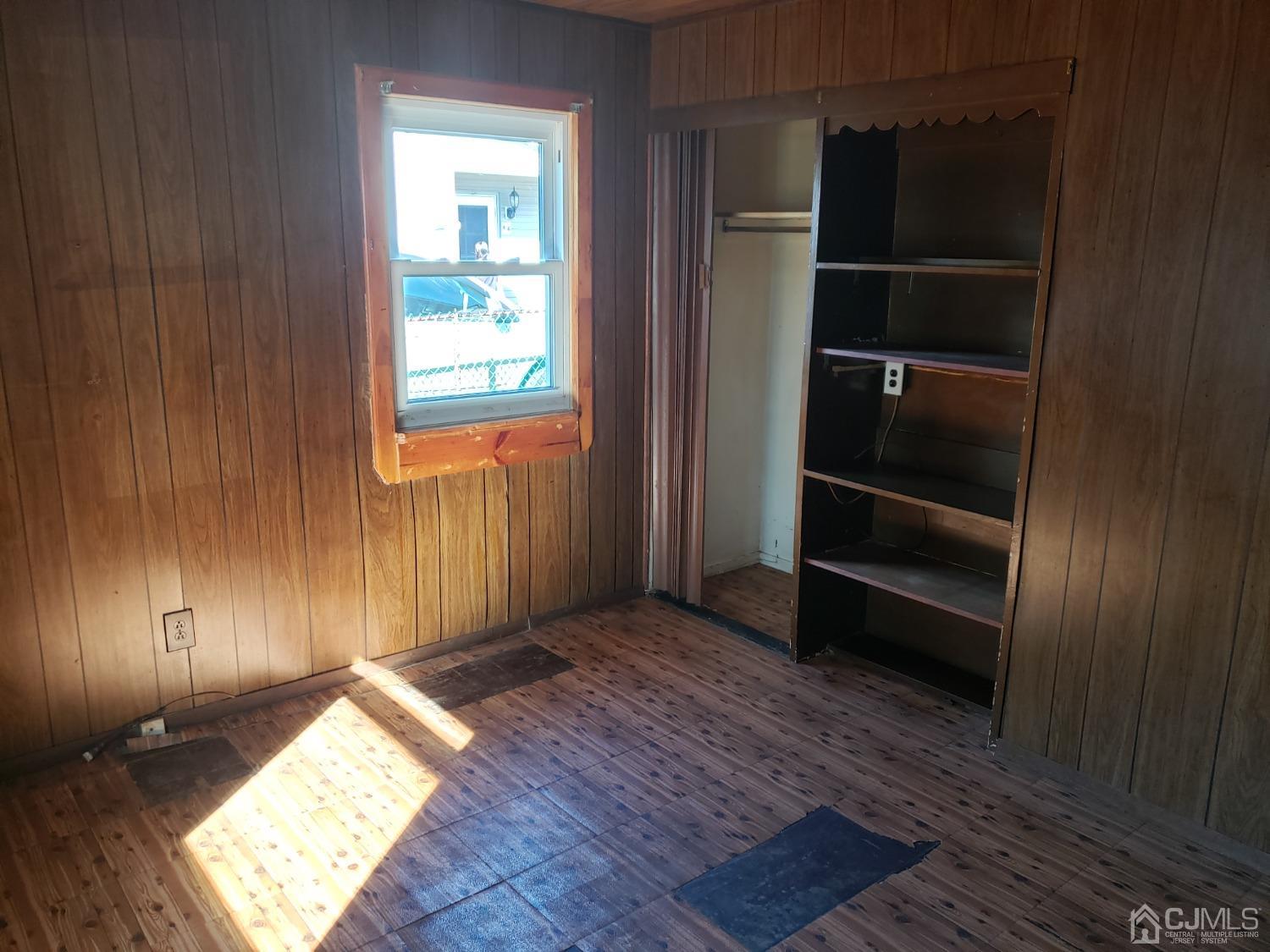 32 Crescent Road Edison, NJ 08817 - Photo 18 of 18 a view of an empty room with a window and wooden floor
