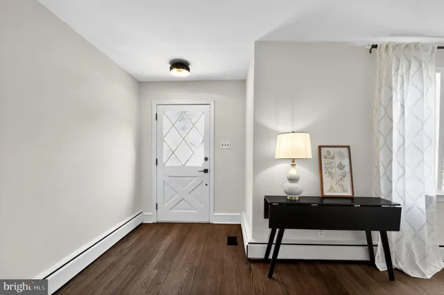 a view of a room with wooden floor and ceiling fan