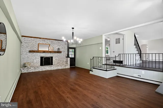 a view of a livingroom with wooden floor and fireplace