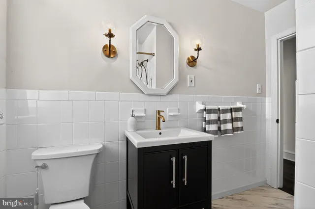 a bathroom with a toilet sink and mirror