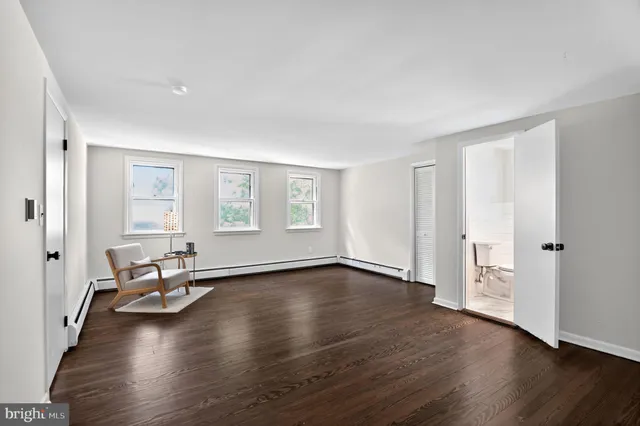 a view of a livingroom with wooden floor and a couch
