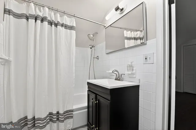 a bathroom with a sink a mirror and a shower curtain