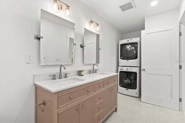 a spacious bathroom with a sink a mirror and a bathtub