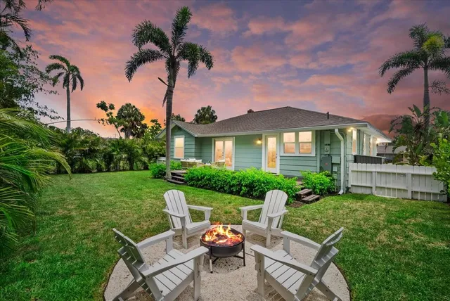 a view of a house with backyard sitting area and garden