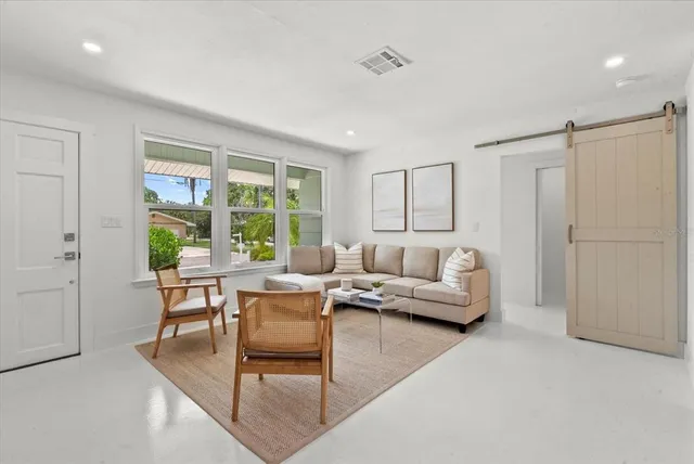a living room with furniture and a large window