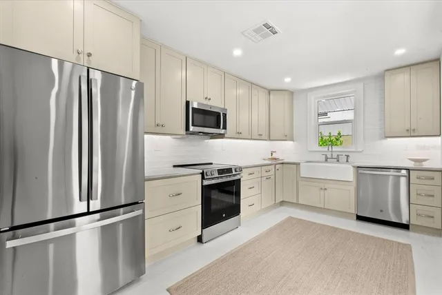 a kitchen with a refrigerator stove and microwave