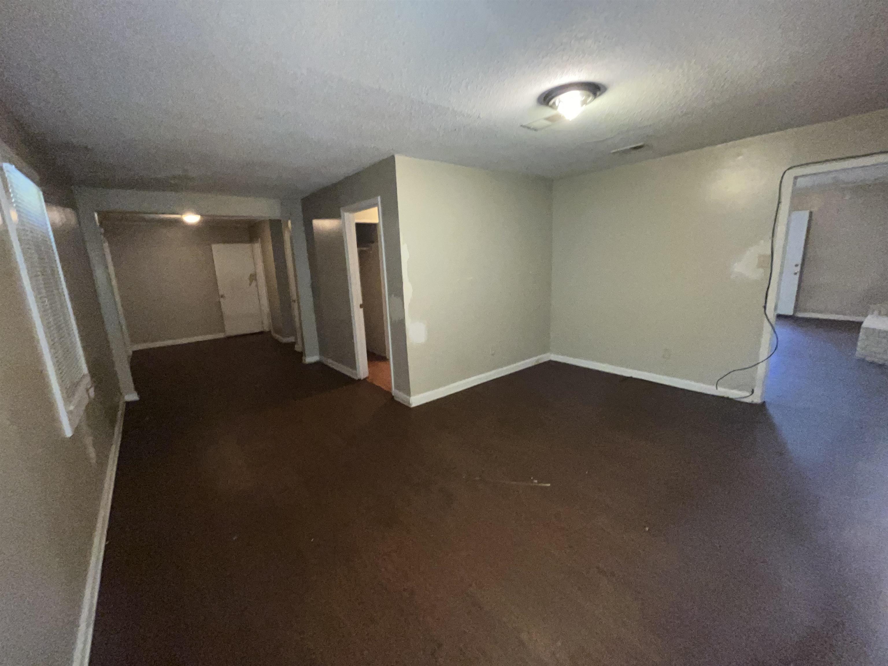 691 Delta Road Memphis, TN 38109 - Photo 14 of 25 an empty room with wooden floor and windows