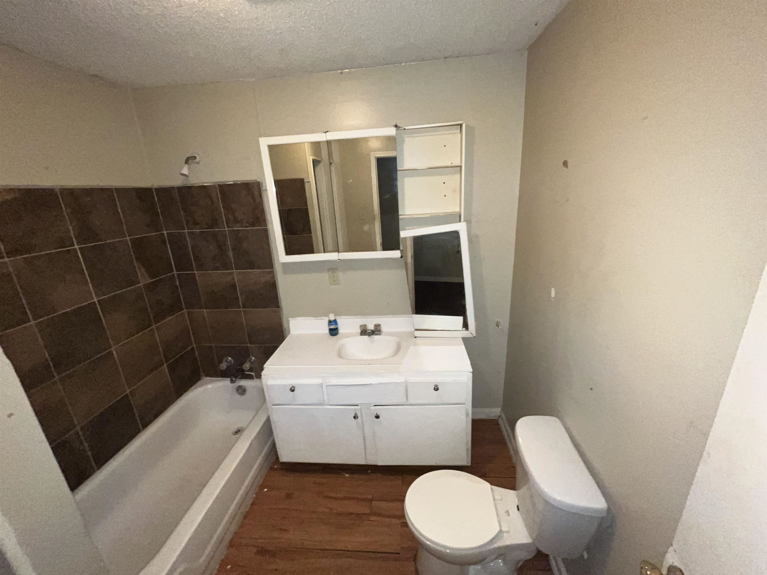 691 Delta Road Memphis, TN 38109 - Photo 15 of 25 a white toilet sitting next to a bathroom sink