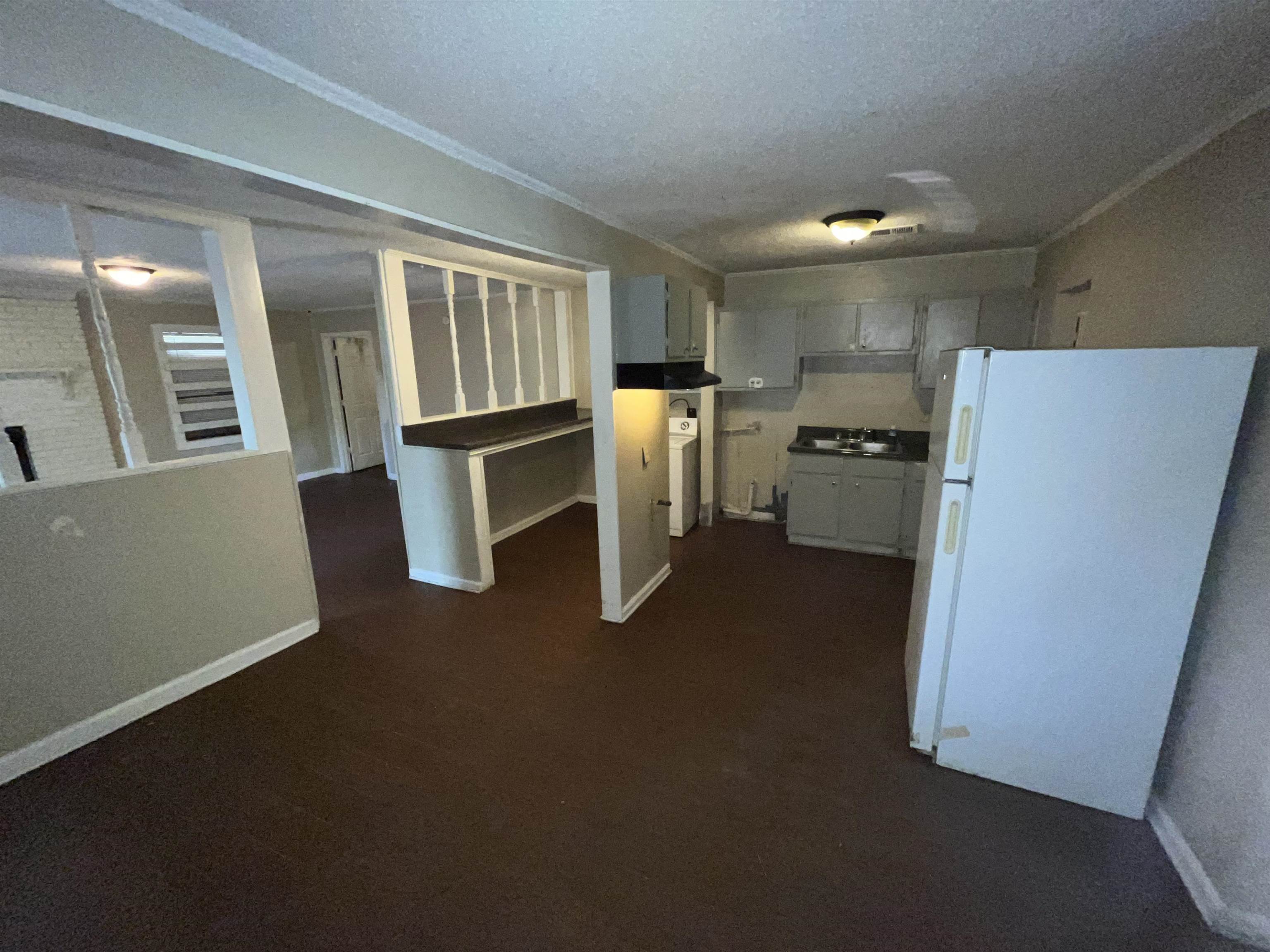 691 Delta Road Memphis, TN 38109 - Photo 5 of 25 a kitchen with refrigerator and cabinets