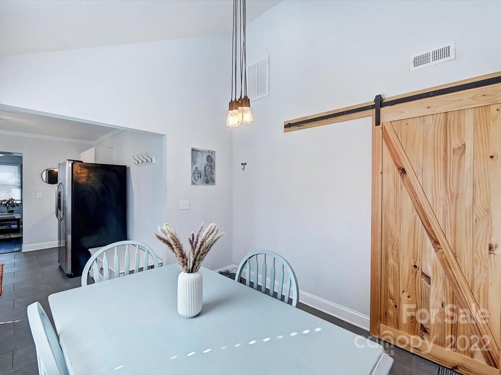 2734 Cowles Road Charlotte, NC 28208 - Photo 12 of 26 a dining room with furniture and potted plant
