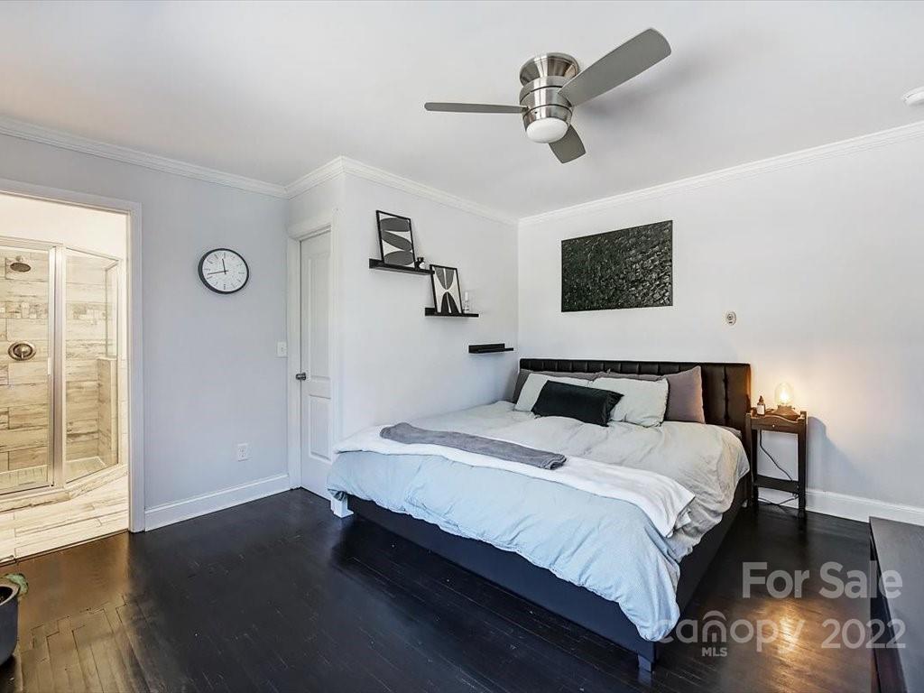 2734 Cowles Road Charlotte, NC 28208 - Photo 15 of 26 a spacious bedroom with a bed and a chandelier