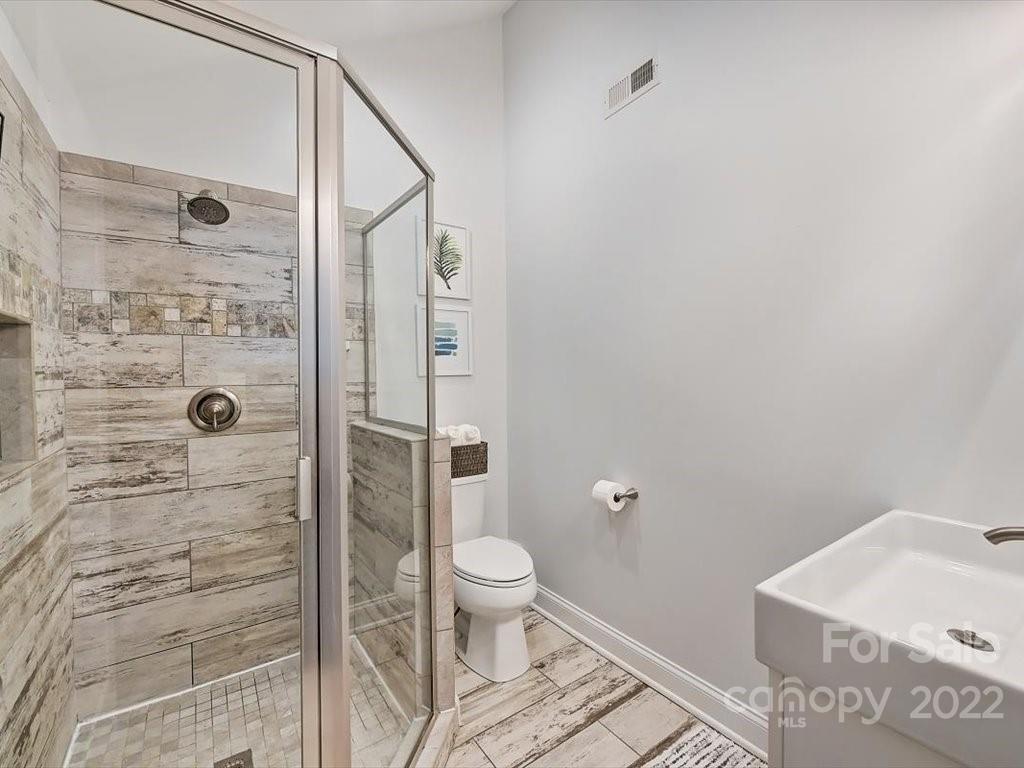 2734 Cowles Road Charlotte, NC 28208 - Photo 16 of 26 a bathroom with a shower and a toilet