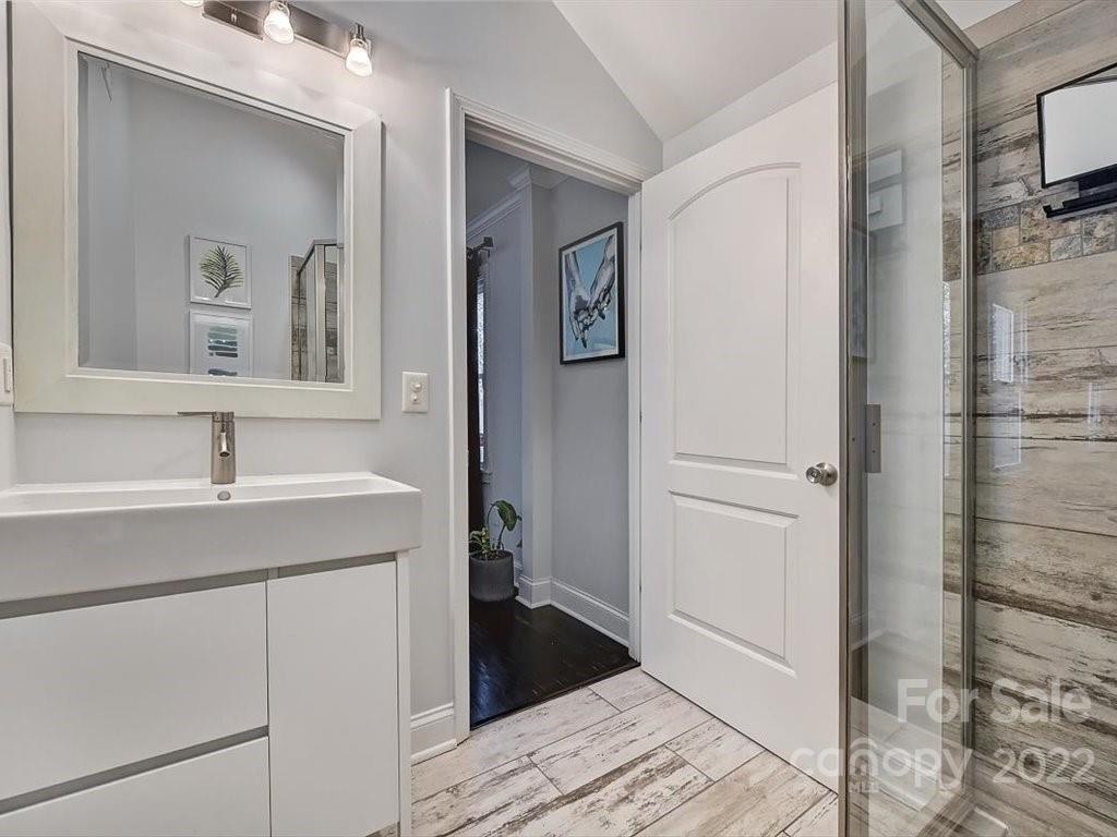 2734 Cowles Road Charlotte, NC 28208 - Photo 17 of 26 a bathroom with a sink and a mirror