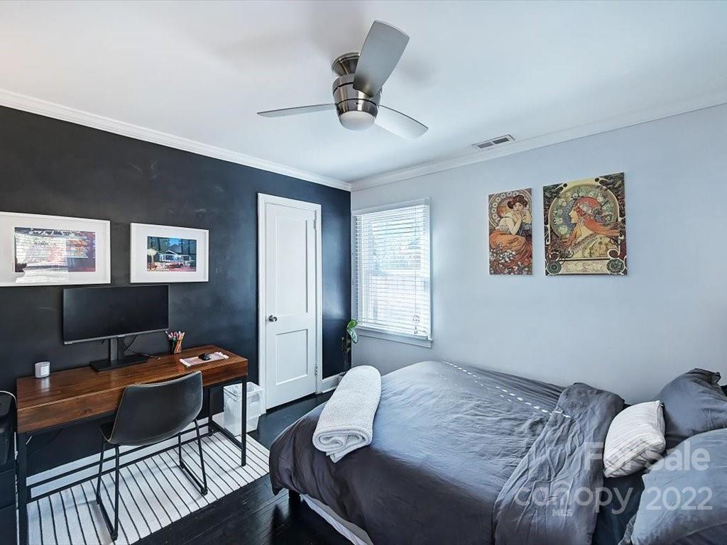 2734 Cowles Road Charlotte, NC 28208 - Photo 19 of 26 a bedroom with a bed and a desk