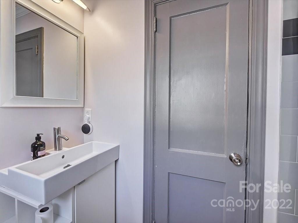 2734 Cowles Road Charlotte, NC 28208 - Photo 20 of 26 a bathroom with a sink and a mirror
