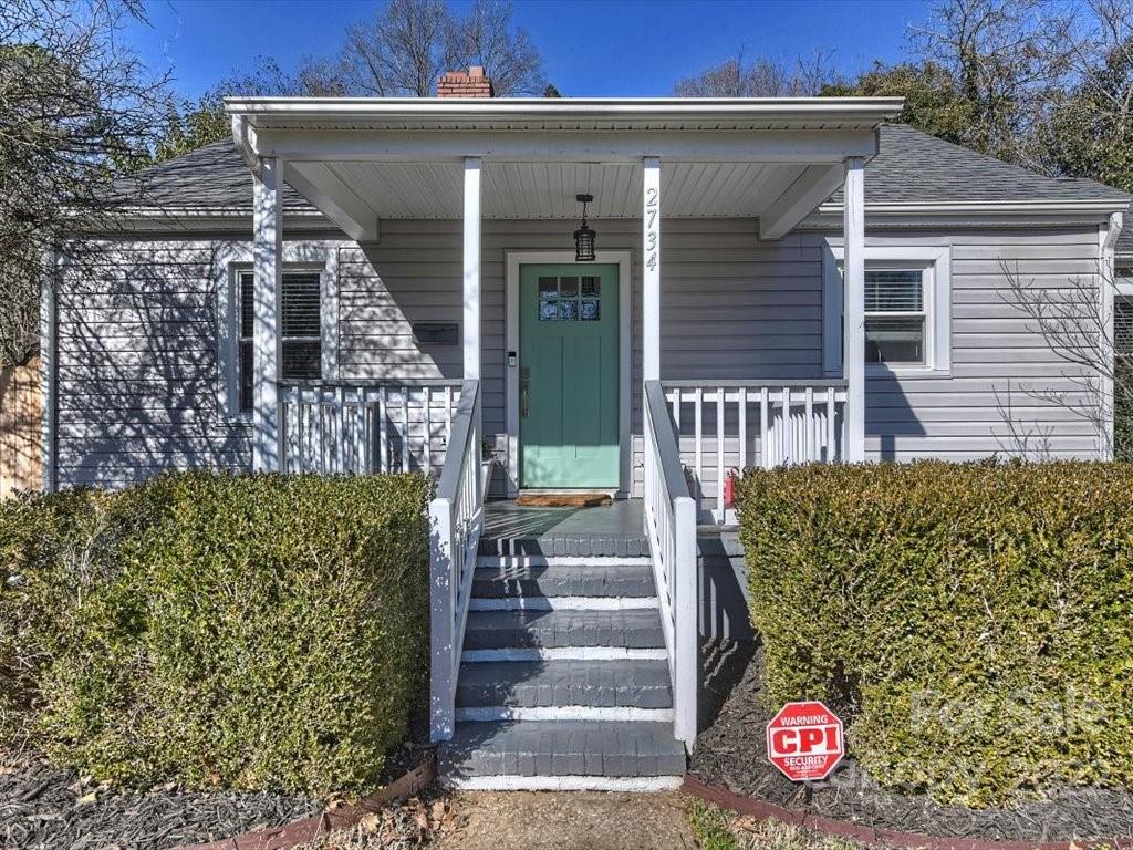 2734 Cowles Road Charlotte, NC 28208 - Photo 2 of 26 a front view of a house with a garden