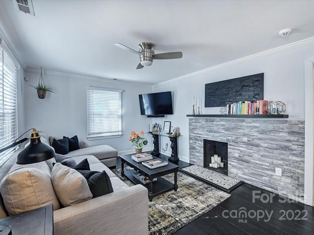 2734 Cowles Road Charlotte, NC 28208 - Photo 3 of 26 a living room with furniture a flat screen tv and a fireplace