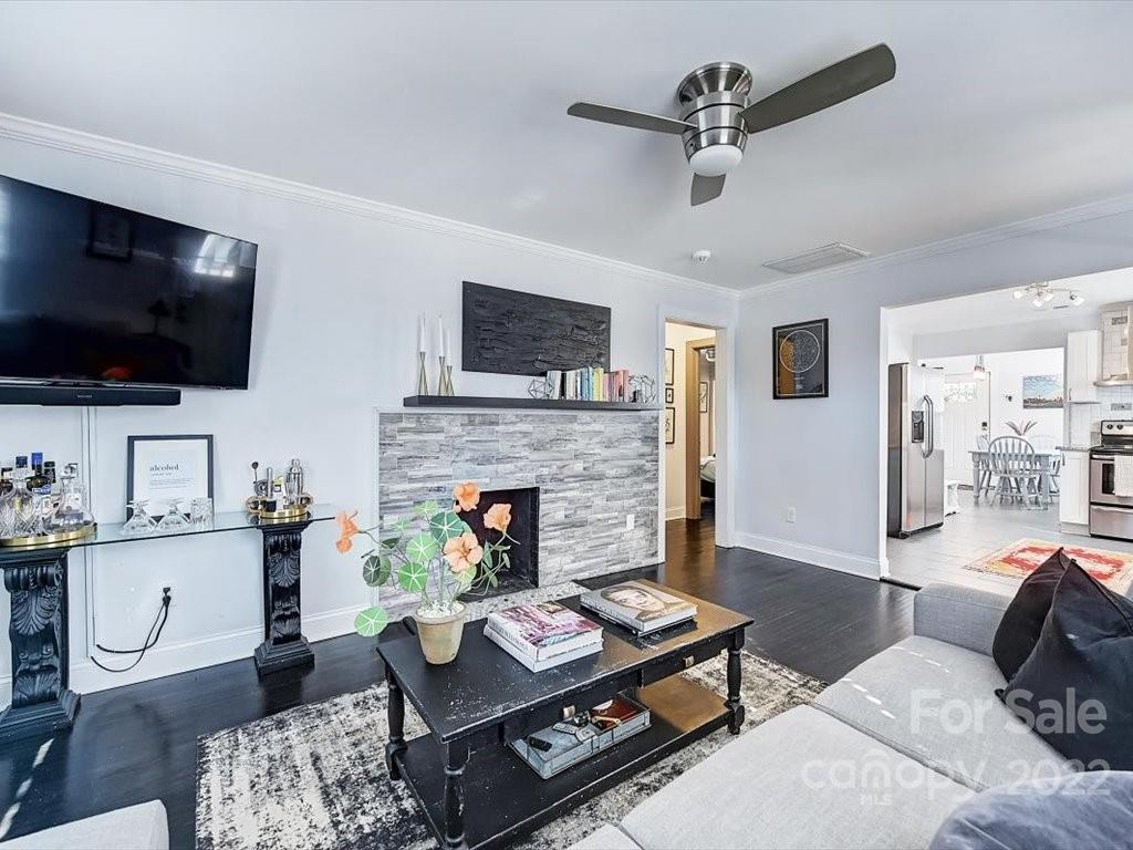 2734 Cowles Road Charlotte, NC 28208 - Photo 6 of 26 a living room with furniture a flat screen tv and a fireplace