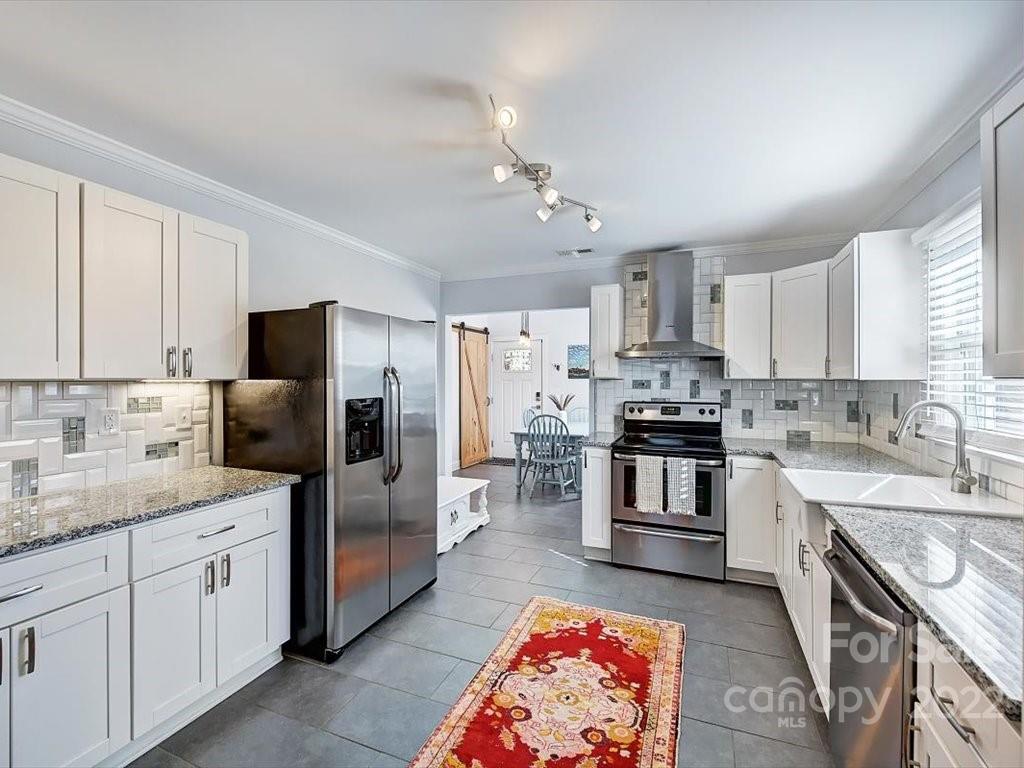 2734 Cowles Road Charlotte, NC 28208 - Photo 7 of 26 a large kitchen with stainless steel appliances granite countertop a sink stove and refrigerator