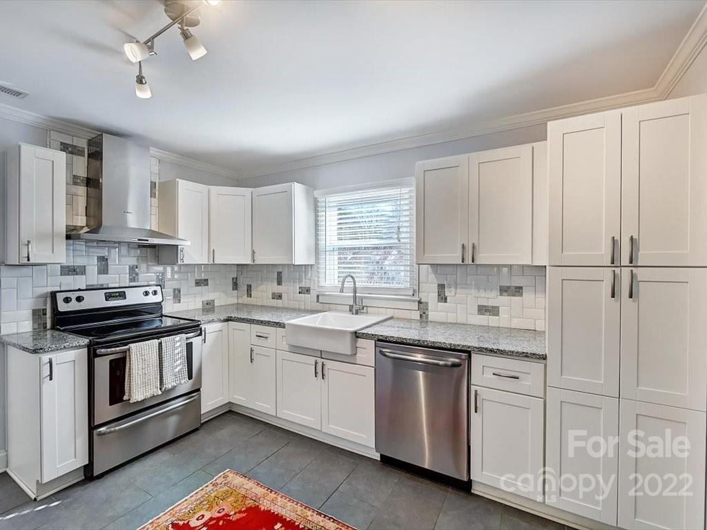 2734 Cowles Road Charlotte, NC 28208 - Photo 9 of 26 a kitchen with white cabinets appliances and a sink