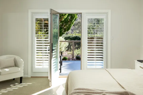 a bedroom with furniture and a window