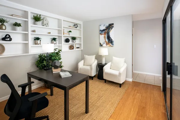 a living room with furniture and wooden floor