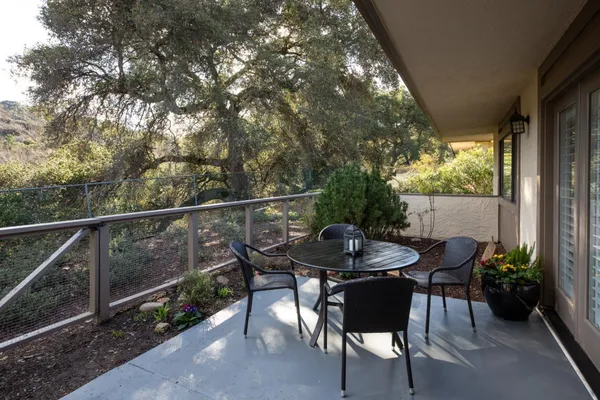 a view of a chairs and table in the patio