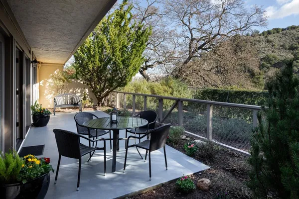 a view of a chairs and table in the patio
