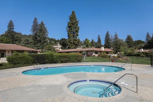 a view of a swimming pool with a yard