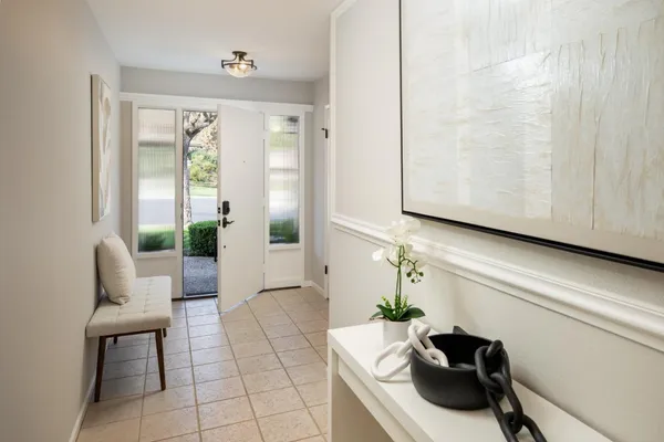 a living room with furniture and a potted plant