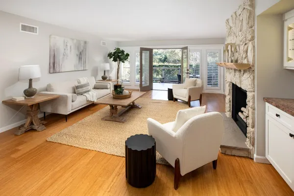 a living room with furniture large window and a fireplace