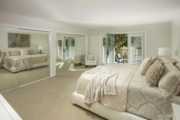 a bedroom with a bed and glass window