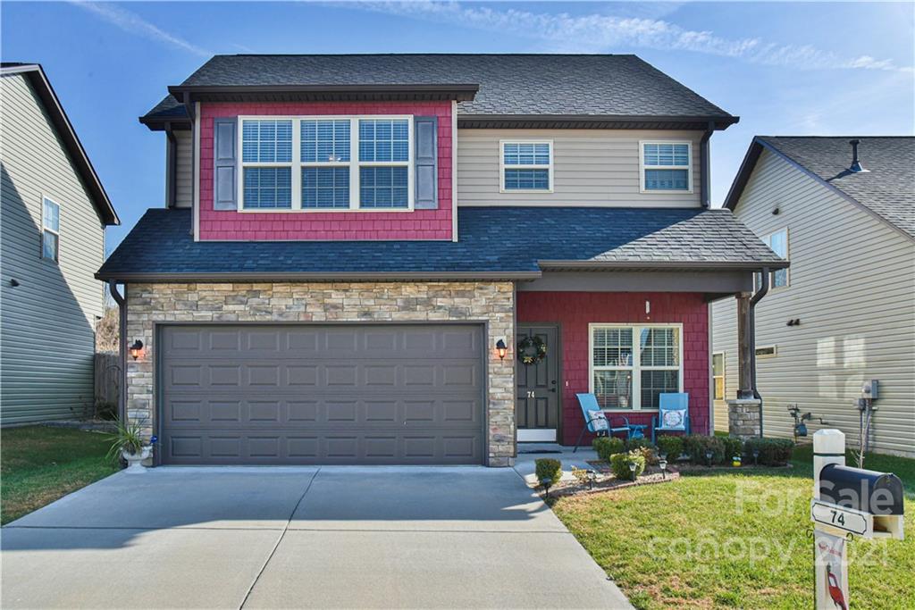 74 North River Road Fletcher, NC 28732 - Photo 2 of 29 a front view of a house with a yard and garage