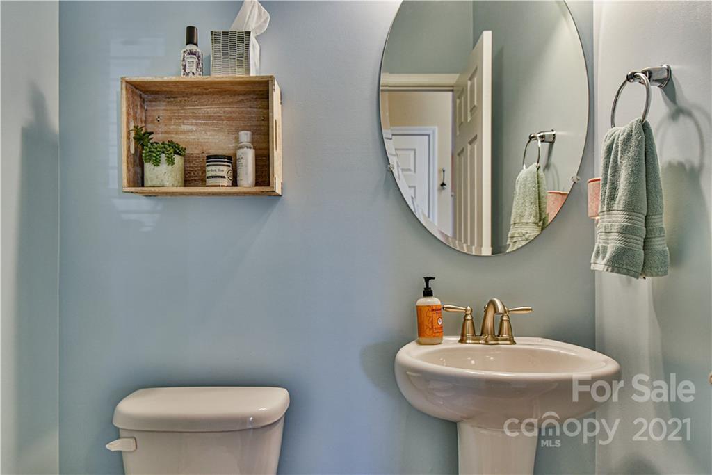 74 North River Road Fletcher, NC 28732 - Photo 11 of 29 a bathroom with a toilet a sink and mirror