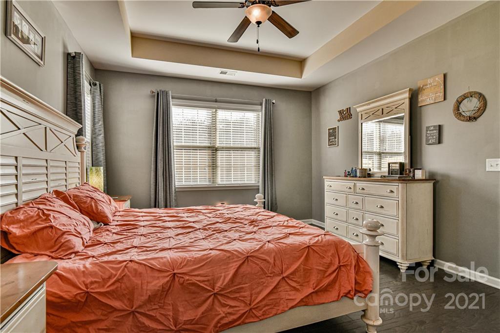 74 North River Road Fletcher, NC 28732 - Photo 13 of 29 a bedroom with a bed a dresser and a window