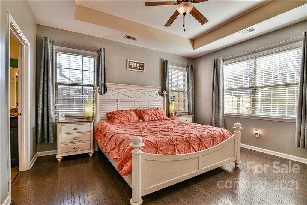 74 North River Road Fletcher, NC 28732 - Photo 14 of 29 a bedroom with a large bed and a chandelier fan