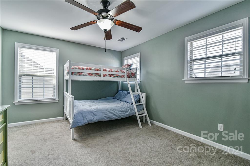 74 North River Road Fletcher, NC 28732 - Photo 22 of 29 a bedroom with a bed and a ceiling fan