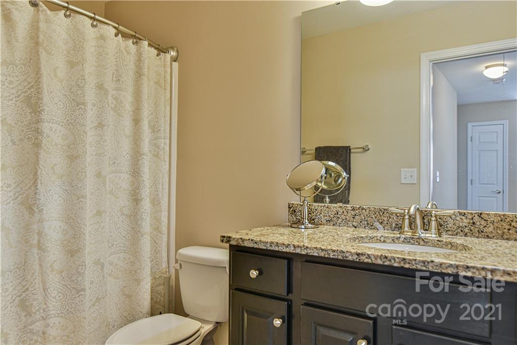 74 North River Road Fletcher, NC 28732 - Photo 23 of 29 a bathroom with a granite countertop sink and a mirror